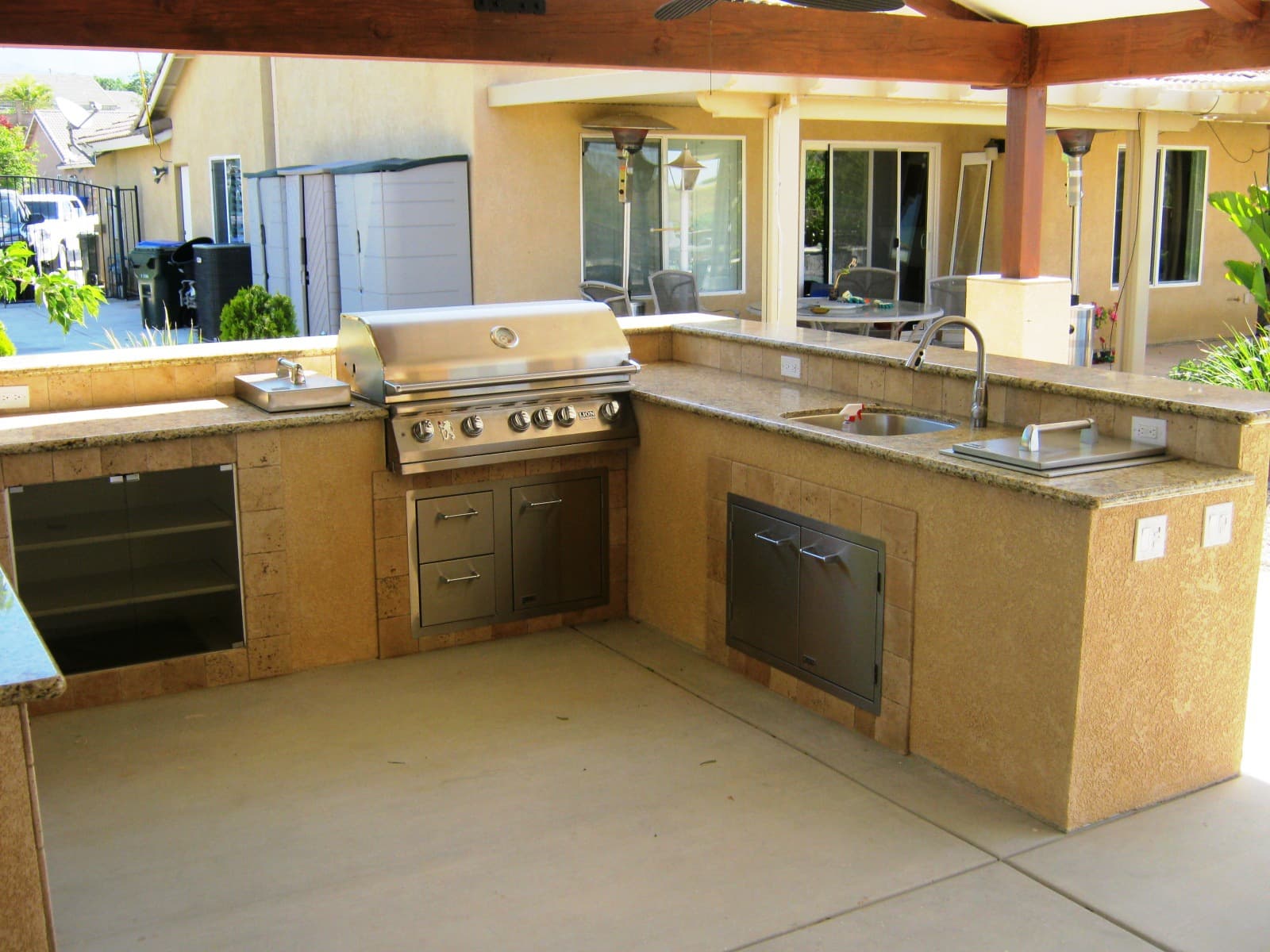 Outdoor kitchen with built-in BBQ and seating